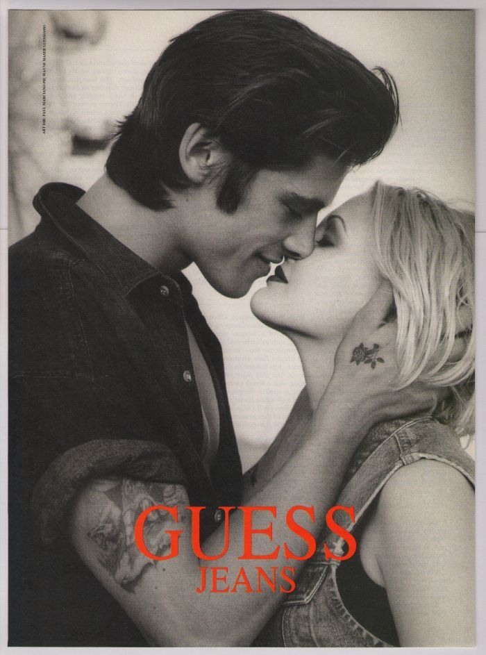 Vintage GUESS Jeans print advertisement featuring intimate black-and-white couple imagery, emblematic of the brand’s sexually charged Los Angeles campaign language in the 1980s